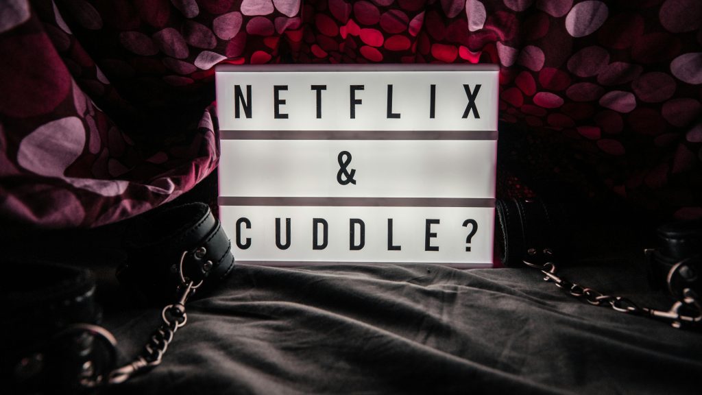 Lightbox with 'Netflix & Cuddle?' message surrounded by cozy setting and decor.